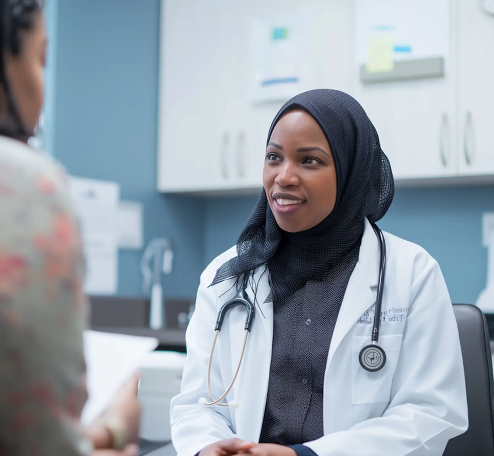 Doctor in a white coat speaking with a patient